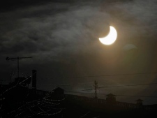 The moon passes in front of the sun during a partial solar eclipse in Moscow, Russia, Tuesday, Jan. 4, 2011. (AP Photo/Misha Japaridze)