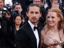 Actors Shia LaBeouf, left, and Jessica Chastain arrive for the screening of Lawless at the 65th international film festival, in Cannes, southern France, Saturday, May 19, 2012. (AP Photo/Joel Ryan)