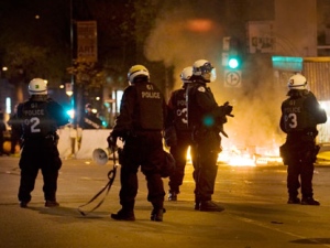 Riot police gather near a fire during a demonstration in Montreal, Saturday, May 19, 2012. A plan to restore order in Montreal appeared to erupt in smoke late Saturday, with a fiery blockades blazing on busy downtown streets. THE CANADIAN PRESS/Graham Hughes