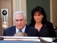 Dominique Strauss-Kahn, former head of the International Monetary Fund, leaves his home in New York with his wife Anne Sinclair on his way to court on Tuesday, Aug. 23, 2011. (AP Photo/David Karp)