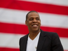 Entertainer Shawn "Jay-Z" Carter smiles in between interviews, after a news conference at Philadelphia Museum of Art on Monday, May 14, 2012, in Philadelphia. The rapper announced plans for a two-day music festival in Philadelphia's at Fairmount Park, featuring nearly 30 acts "that embody the American spirit" on Labor Day weekend. (AP Photo/Matt Rourke)