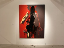 A visitor to the Goodman Gallery in Johannesburg holds his hands over what could be a codpiece accentuating the genitals on a painting entitled "The Spear" depicting President Jacob Zuma, by South African artist Brett Murray, Friday, May 18, 2012.  South Africa's governing party said it will demand the removal of the painting  from the exhibition. (AP Photo/Denis Farrell)