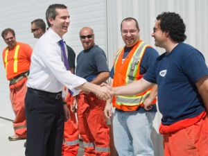 Ontario Premier Dalton McGuinty, left, shakes hands with Highway 407 ETR workers in Woodbridge, Ont., on Thursday, May 24, 2012, before announcing the Highway 407 East Project in Durham Region, which will create 900 direct construction jobs and help commuters get to work faster with the expansion of Highway 407. (THE CANADIAN PRESS/Nathan Denette)