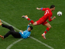 Portugal's Cristiano Ronaldo, right, controls the ball prior to scoring a goal past North Korea goalkeeper Ri Myong Guk, left, during the World Cup group G soccer match between Portugal and North Korea in Cape Town, South Africa, Monday, June 21, 2010. Portugal won 7-0. (AP Photo/Roberto Candia)