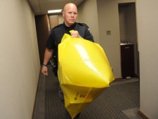 A police officer removes a package containing a human foot from the Conservative Party headquarters in Ottawa on Tuesday, May 29, 2012. (THE CANADIAN PRESS/Sean Kilpatrick)