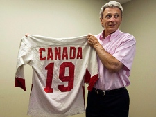 Canadian hockey legend Paul Henderson, 67, who scored the game-winning goal during the 1972 Summit Series against the Soviet Union, holds his original 1972 Canada jersey in his office in Mississauga, Ont., on Monday, June 7, 2010. A B.C.-based company is trying to bring hockey player Paul Henderson's most famous jersey back to Canada.(THE CANADIAN PRESS/Nathan Denette)