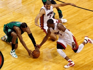 Boston Celtics' Paul Pierce (34) and the Miami Heat's Dwyane Wade (3) and Shane Battier (31) go after a loose ball during the second half of Game 2 in their NBA Eastern Conference finals playoffs series, Wednesday, May 30, 2012, in Miami. (AP Photo/Wilfredo Lee)