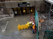 Crews work to contain water after heavy rains caused flooding in the Royal Bank Plaza and Union Station in Toronto on Friday, June 1, 2012. THE CANADIAN PRESS/Aaron Vincent Elkaim