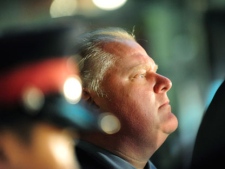 Toronto Mayor Rob Ford watches the activity outside the Eaton Centre in Toronto, Saturday, June 2, 2012. A shooting that sparked mass panic at Toronto's Eaton Centre killed one person Saturday and injured seven others. THE CANADIAN PRESS/Victor Biro