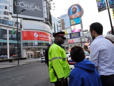 Police talk to bystanders outside the Eaton Centre shopping mall in Toronto, Saturday, June 2, 2012. Shots were fired at Toronto's downtown Eaton's Centre Saturday evening and at least two people were taken out on stretchers, local media outlets were reporting. THE CANADIAN PRESS/Victor Biro