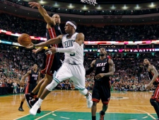 Boston Celtics' Rajon Rondo dumps off the ball as he is pressured by Miami Heat's Shane Battier, centre left, during overtime of Game 4 in the NBA Eastern Conference finals in Boston on Sunday, June 3, 2012. The Celtics won 93-91, tying the series at 2-2. (AP Photo/Charles Krupa)