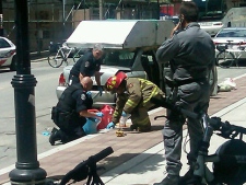 Emergency crews go through items removed from a car near the G20 security zone. (Pedro Cristovao - special to CP24.com)