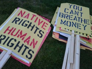 Protesters prepare several signs ahead of a large protest scheduled at Queen's Park Thursday afternoon.