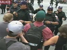 Protesters and police clash in front of the G20 detention centre on Eastern Avenue Sunday.
