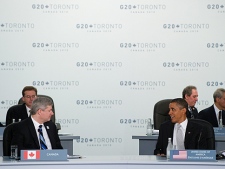 U.S. President Barack Obama, right, and Canadian Prime Minister Stephen Harper talk during the opening plenary session at the G20 Summit in Toronto June 27, 2010. (AP Photo/Saul Loeb, Pool)