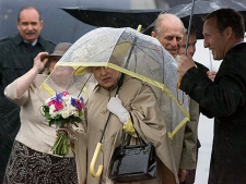 The Queen  and her husband Prince Philip are greeted by Canadian  Defence Minister Peter MacKay, right, as they arrive in Halifax in a steady rain on Monday, June 28, 2010. The royal couple are on a nine-day tour of Canada. (THE CANADIAN PRESS/Andrew Vaughan)