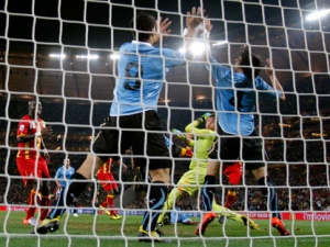 Uruguay's Luis Suarez, left, touches the ball with his hands to give away a penalty during the World Cup quarterfinal soccer match between Uruguay and Ghana at Soccer City in Johannesburg, South Africa, Friday, July 2, 2010. Uruguay reached the World Cup semifinals for the first time since 1970, beating Ghana 4-2 on penalties after a 1-1 draw Friday. (Eugene Hoshiko/AP Photo)