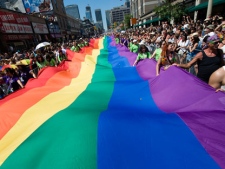 People take part in the Pride Parade in Toronto on Sunday, July 4, 2010. THE CANADIAN PRESS/Adrien Veczan