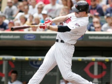 Minnesota Twins' Justin Morneau connects for an RBI-double off Tampa Bay Rays' starting pitcher James Shields during the first inning of a baseball game, Sunday, July 4, 2010, in Minneapolis. (AP Photo/Paul Battaglia)