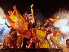 Spanish fans celebrate in a fountain in downtown Madrid after Spain defeated the Netherlands to win the World Cup soccer final, taking place in South Africa, on Sunday, July 11, 2010. Spain won 1-0. (AP Photo/Arturo Rodriguez)