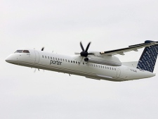 A Porter Airlines Bombardier Q400 turboprop does a fly by at the city centre airport in Toronto, in this Aug. 29, 2006 photo. (THE CANADIAN PRESS/Adrian Wyld)