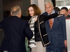 Conrad Black and his wife, Barbara Amiel, are checked at security as they arrive for his bail hearing at Federal Court Friday, July 23, 2010 in Chicago. (THE CANADIAN PRESS/Ryan Remiorz)