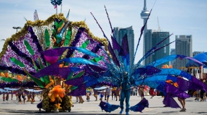 Revelers take part in the 2010 Caribana Parade in Toronto on Saturday, July 31, 2010. THE CANADIAN PRESS/Adrien Veczan