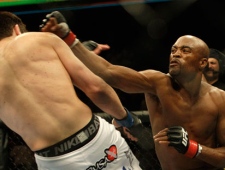 Anderson Silva, right, punches Chael Sonnen during a Middleweight Championship UFC mixed martial arts match in Oakland, Calif., Saturday, Aug. 7, 2010. Silva won by submission in the fifth round to retain the championship.(Jeff Chiu/AP Photo)