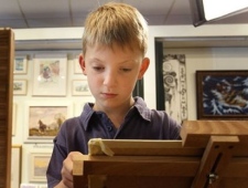 In this Thursday, Aug. 12, 2010 Kieron Williamson, an eight-year-old painting prodigy is seen working on a drawing in Holt, Norfolk in England.(Kirsty Wigglesworth/AP Photo) 