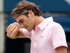 Roger Federer of Switzerland wipes his brow during the final of Rogers Cup ATP tennis action against Andy Murray of Great Britain in Toronto Sunday, August 15, 2010. Fedrerer lost the first set 5-7 to Murray. (Nathan Denette/THE CANADIAN PRESS)
