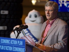The iconic mascot Bib looks on as Prime Minister Stephen Harper addresses the crowd at the Michelin tire factory in Waterville, N.S. on Wednesday, August 18, 2010. Harper is on a three-day tour of the Maritimes. (THE CANADIAN PRESS/Andrew Vaughan)