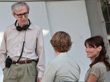 French President Nicolas Sarkozy's wife Carla Bruni Sarkozy, right, is pictured with U.S director Woody Allen, left, and U.S actor Owen Wilson, center, during the filming of "Midnight in Paris", directed by Woody Allen, in Paris, Wednesday, July 28, 2010. (AP Photo/Thibault Camus)