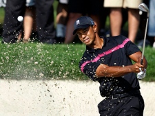 Tiger Woods  hits from a bunker on the 11th hole during the first round of The Barclays golf tournament Thursday, Aug. 26, 2010, in Paramus, N.J. (AP Photo/Mel Evans)