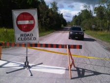 Police block Beechgrove Road, near Orangeville, after what is believed to be human remains were found there on Sunday, Sept. 5, 2010.