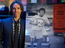 Steve Nash poses for photographers with a poster for the movie Into the Wind a celebration of Terry Fox which Nash directed along with Ezra Holland in Toronto on Sunday, Sept 12, 2010. (THE CANADIAN PRESS/Pawel Dwulit)