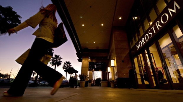A customer walks out of a Nordstrom store in Los Angeles on Feb. 11, 2011.