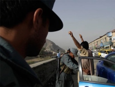 Policemen frisk commuters at a checkpoint set up as a security measure a day ahead of parliamentary elections in Kabul, Afghanistan, Friday Sept. 17, 2010. Afghanistan will elect the lower house of its parliament on Sept. 18. (AP / Saurabh Das)