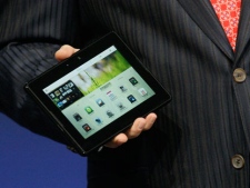 Mike Lazaridis, president and co-CEO of Research in Motion Ltd. (RIM), holds the new PlayBook during the BlackBerry developers conference 2010 in San Francisco, Monday, Sept. 27, 2010. (AP Photo/Jeff Chiu)