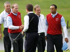 U.S. team members Tiger Woods, right, and Steve Stricker, second left, congratulate Europe's Lee Westwood, center, and Luke Donald, second right, as caddie Steve Williams looks on, on the third day of the 2010 Ryder Cup golf tournament at the Celtic Manor Resort in Newport, Wales, Sunday, Oct. 3, 2010.