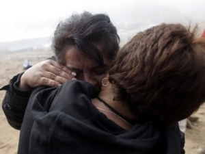 Relatives of trapped miners embrace at the San Jose Mine near Copiapo, Chile, Saturday, Oct. 9, 2010. (Dario Lopez-Mills/AP Photo) 