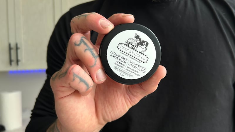 Robert Tanner shows off a product from his Flock and Tallow skincare line. (Emma Convey/CTV News Atlantic)