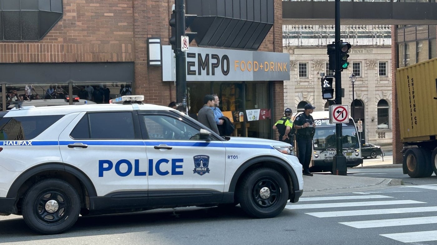 Responding to a bomb threat, police direct people to evacuate at the intersection of Barrington Street and Duke Street, in downtown Halifax, on Monday, Aug. 10, 2026. THE CANADIAN PRESS/Devin Stevens