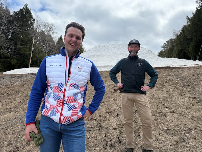 Ski Martock CEO Martin Kejval (left) and Andrew MacLean (centre), operations manager, stand in front of a massive mound of snow on April 21, 2026. They hope to preserve the snow until next season. (CTV News / Callum Smith)