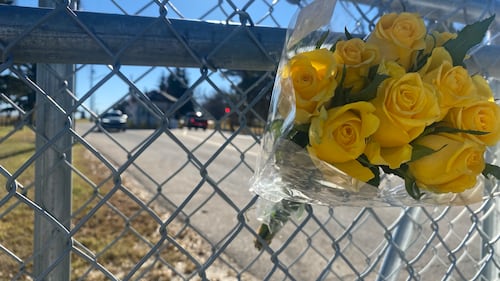 Flowers are seen on the fence of the entrance to CFB Wainwright in eastern Alberta on Oct. 19, 2026, two days after an incident killed four soldiers and injured dozens of others. (Darcy Seaton / CTV News Edmonton)
