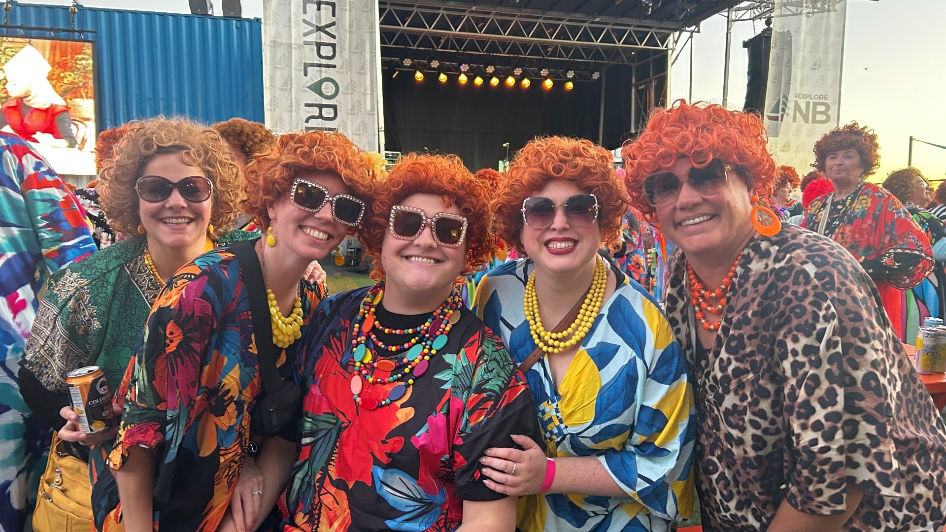 Five people dressed up as Mrs. Roper pose for a photo.