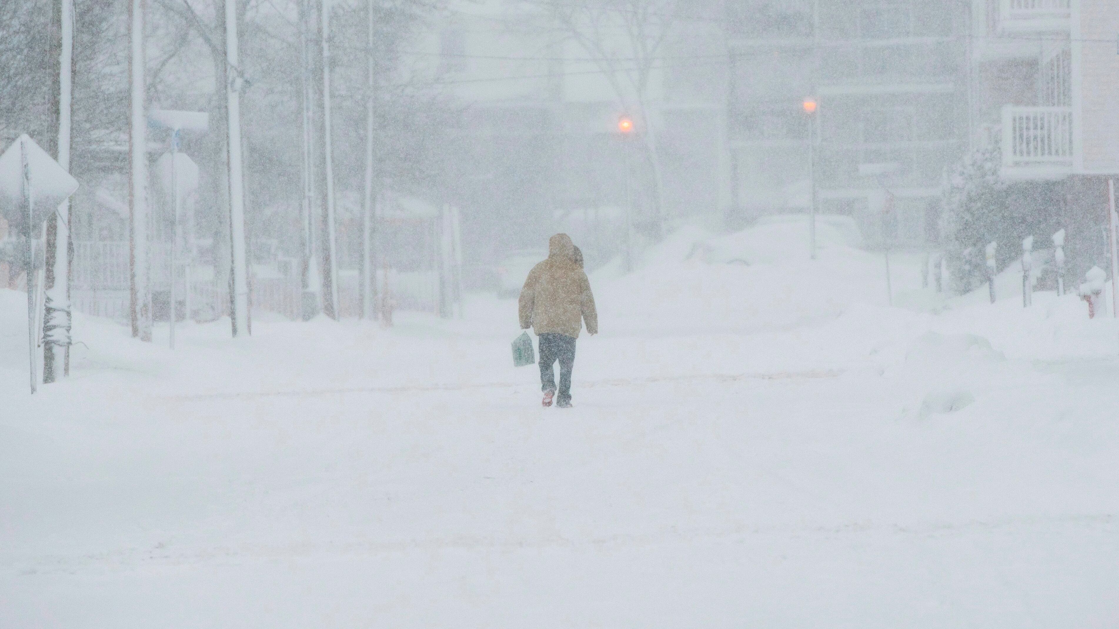 A pedestrian walks down the middle of the road on Victoria Street in Downtown Moncton, N.B., on Thursday, January 4, 2018. THE CANADIAN PRESS/Stephen MacGillivray