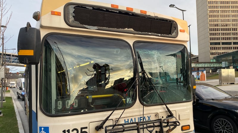 A transit bus is pictured with a shattered windshield.