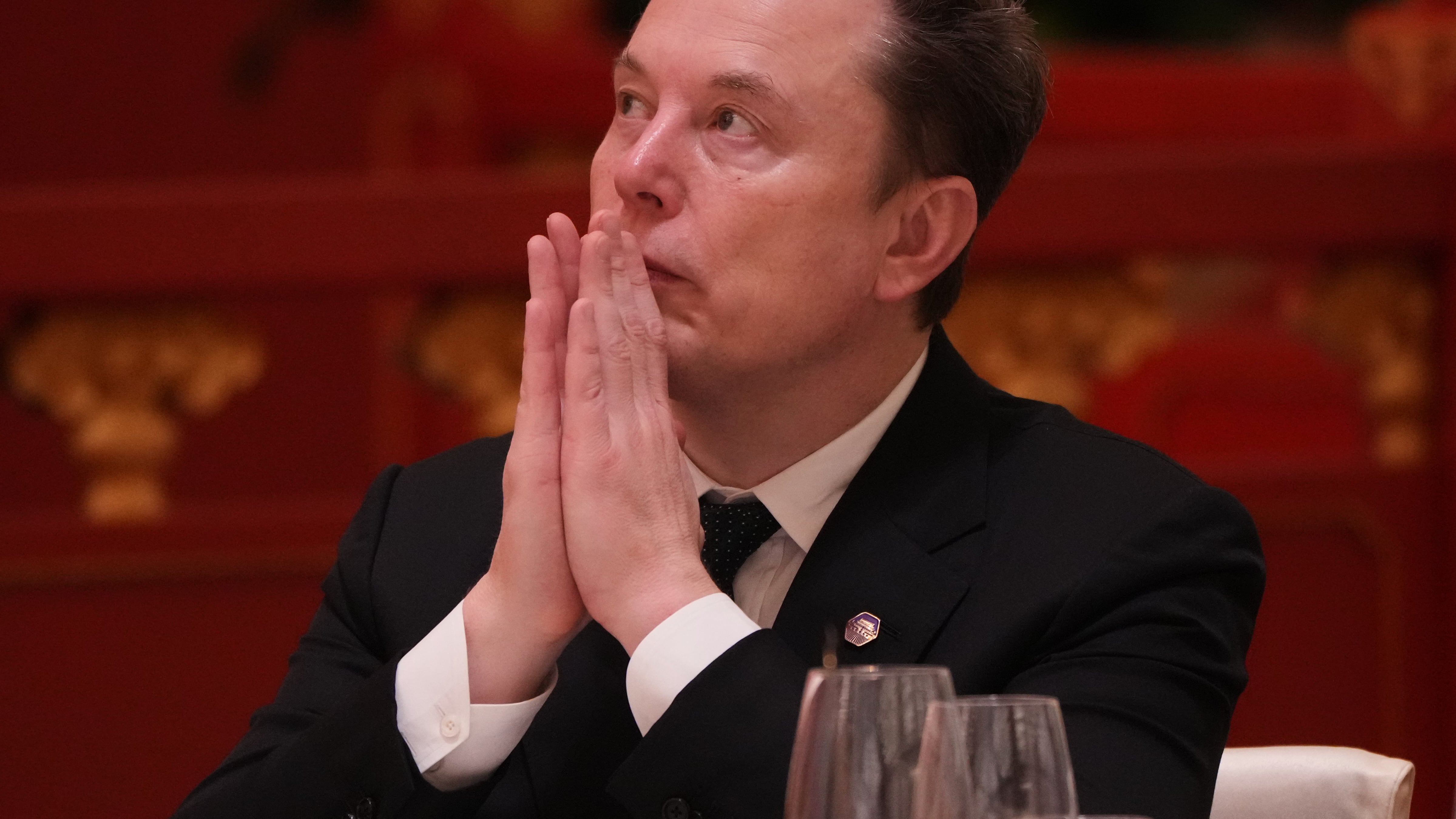 Elon Musk listens to the speech of Chinese President Xi Jinping during a state dinner with U.S. President Donald Trump at the Great Hall of the People in Beijing on May 14, 2026. (Mark Schiefelbein / AP Photo)