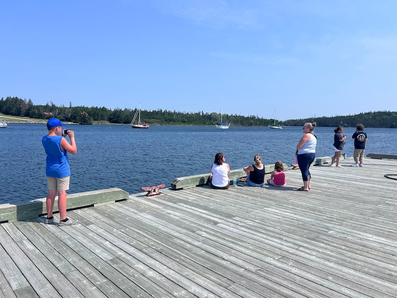 People are pictured along Nova Scotia's Bras d'or Lake on August 5, 2026. (CTV Atlantic / Ryan MacDonald)
