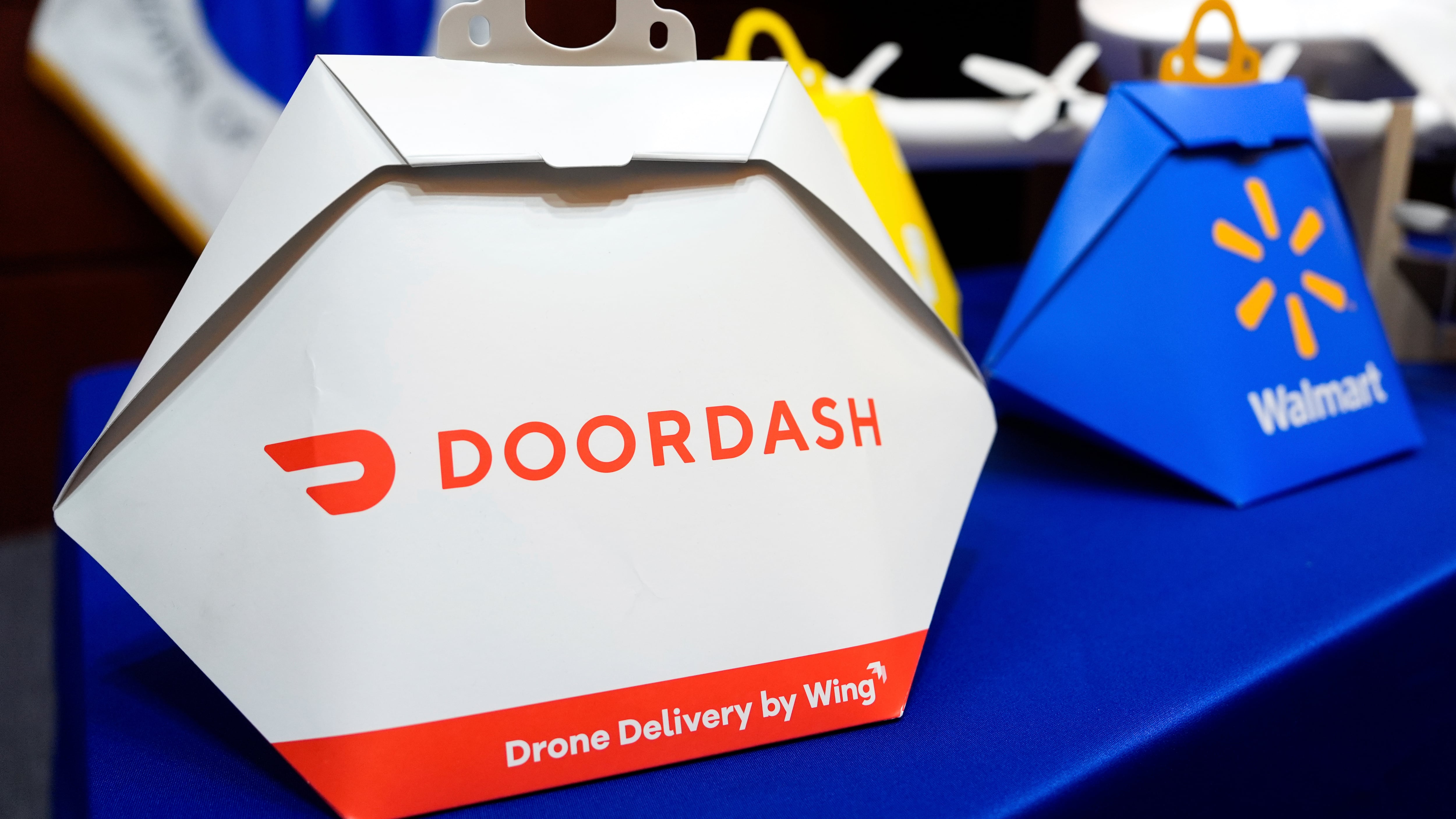DoorDash, Wing and Walmart drone delivery containers are displayed before a news conference at the Department of Transportation on new drone regulations in Washington on Aug. 5, 2025. (Julia Demaree Nikhinson / AP Photo)
